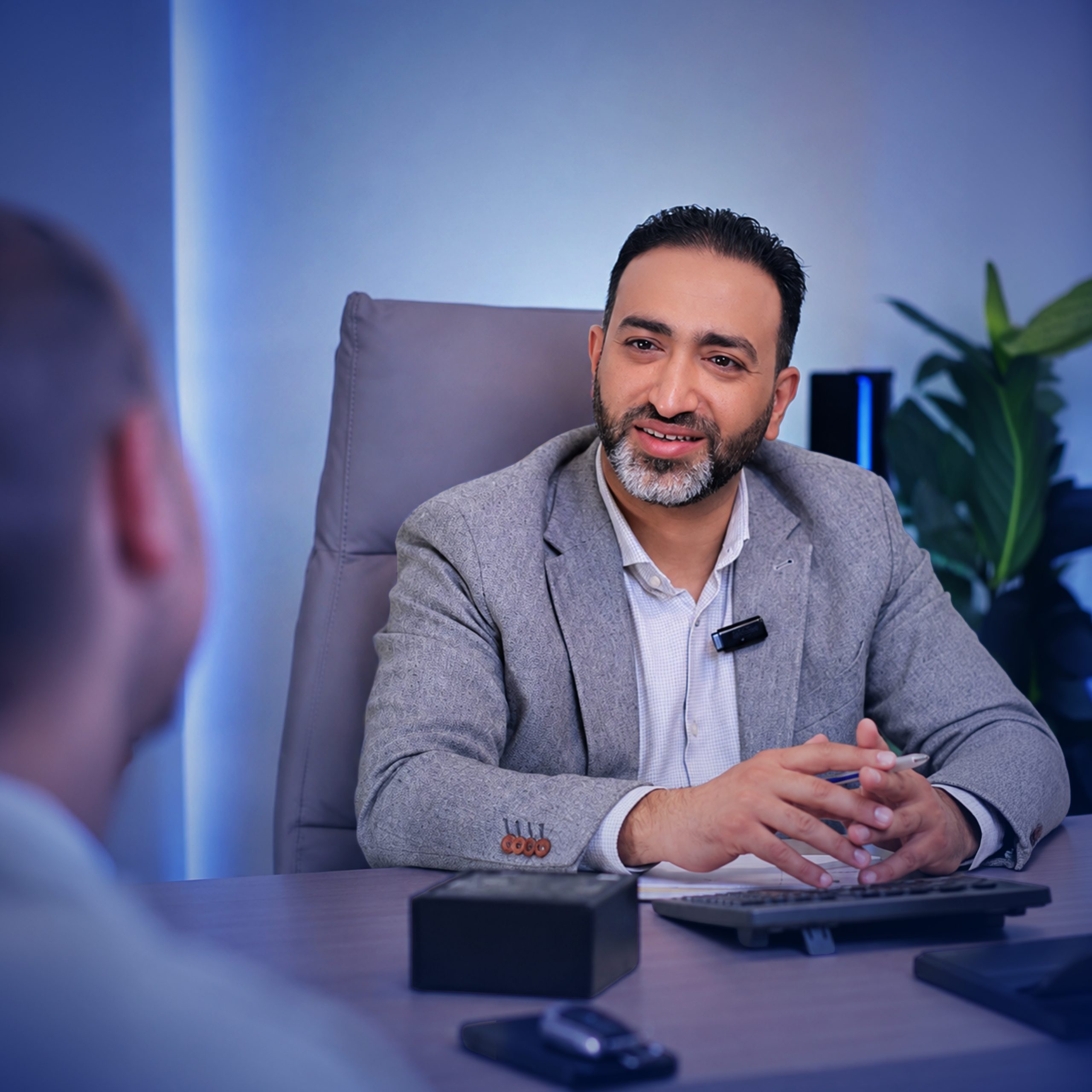 Dr. Ahmed Elwahidi speaking with a patient during a surgical consultation